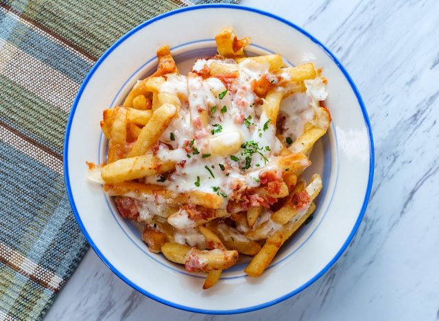 Crispy French fried potatoes loaded with bacon creamy ranch dressing and mozzarella cheese