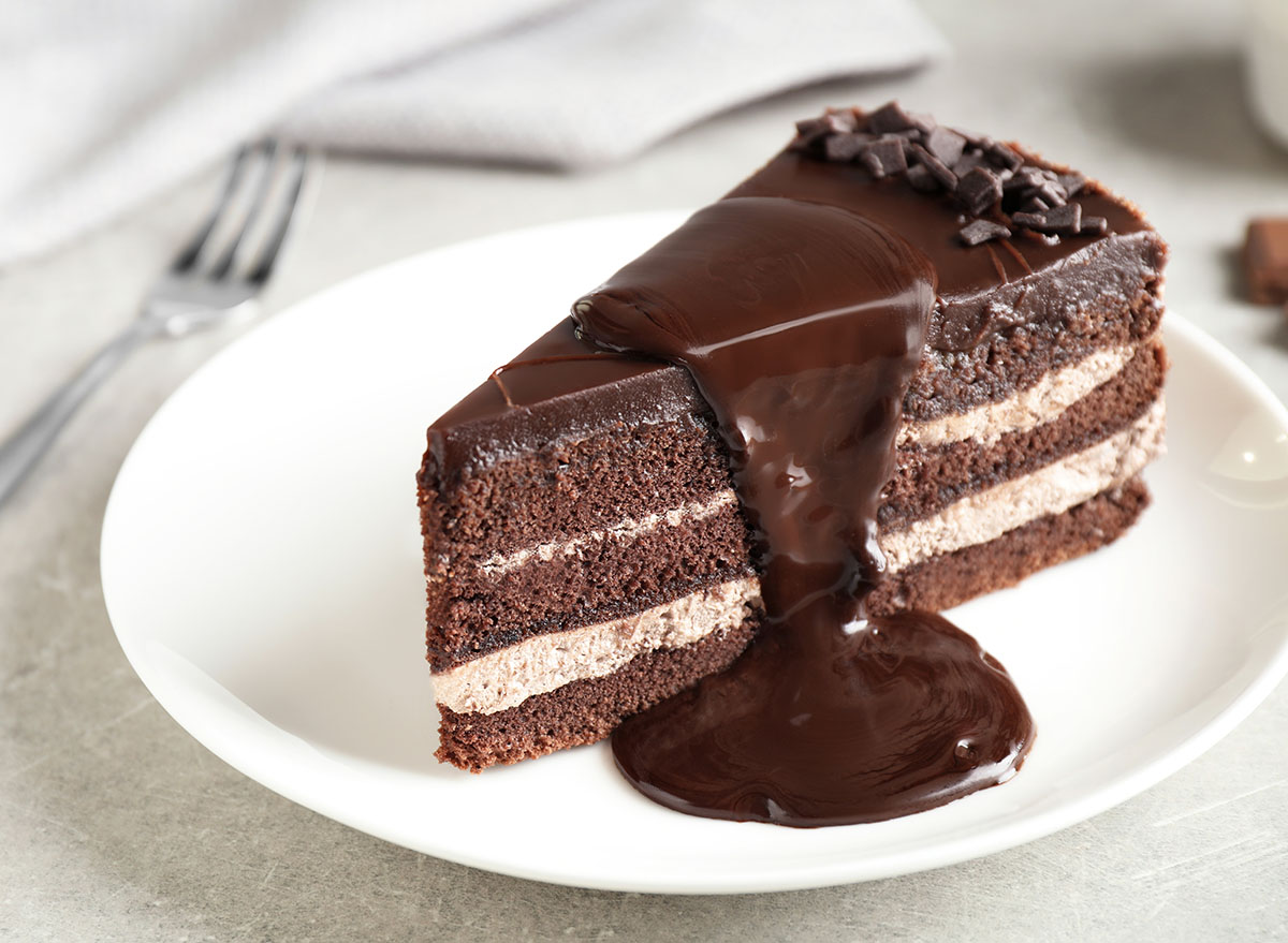 Delicious fresh chocolate cake on light table, closeup