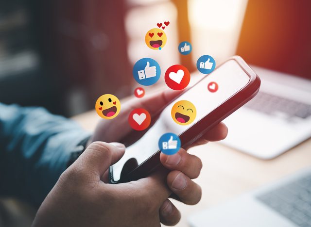 Social media and digital online concept, man using smart phone with Social media. The concept of living on vacation and playing social media. Social Distancing ,Working From Home concept.