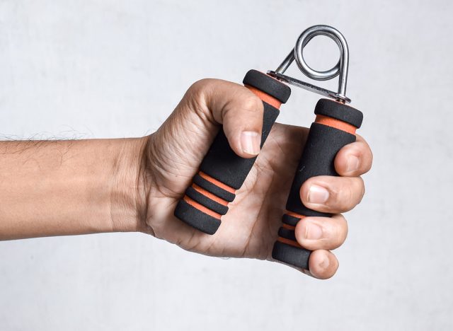 man gripping hand exercise gripper