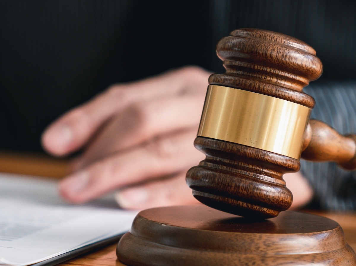 Lawyer,Man,Holding,Pen,With,Contract,Or,Agreement,Document,To