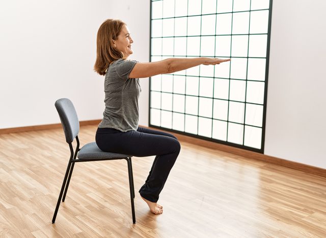 Chair Sit-to-Stand with Pause, Middle age caucasian woman smiling confident training at sport center
