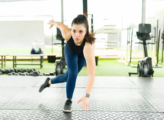 Active young woman doing a cardio workout routine and working out with lateral bound exercises