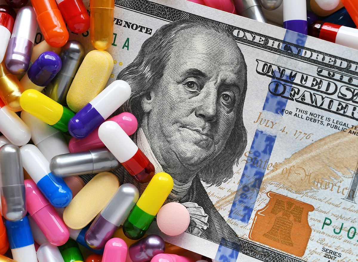 Pills on money dollars - Medicine prescription drugs cost concept - healthcare insurance expenses