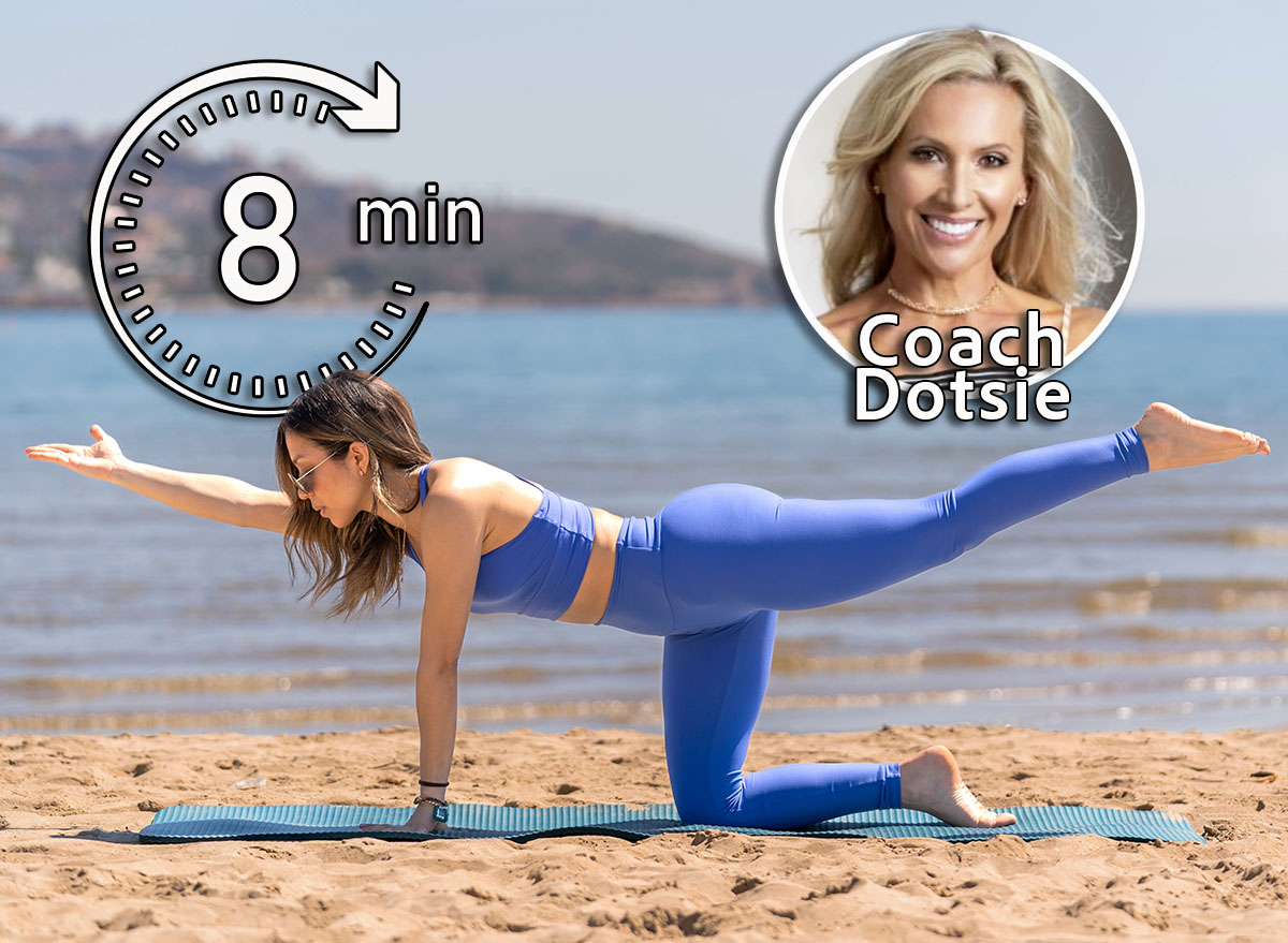 Dotsie Bausch, 5 Gentle Exercises That Loosen Your Body Better Than a Massage for Women Over 40, cover, A woman in blue performs the bird dog pose on a beach, extending one arm and the opposite leg. The serene ocean and distant hills enhance the tranquil setting of this fitness activity.
