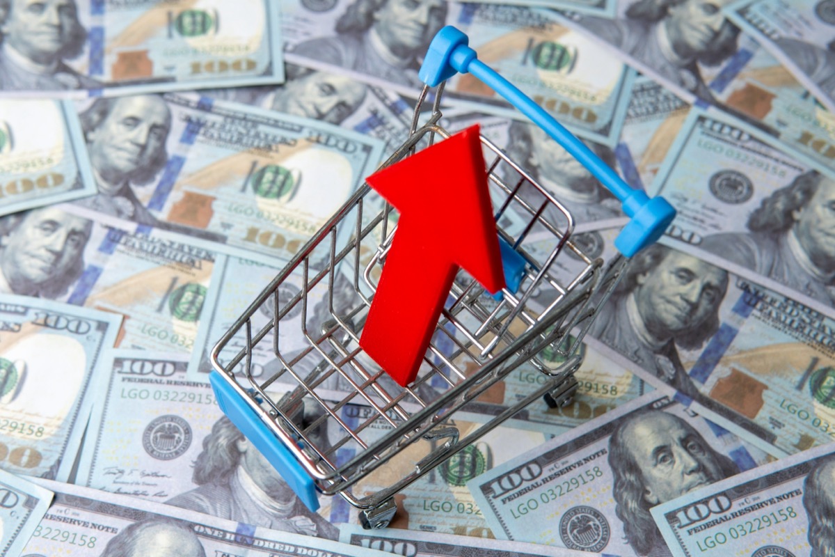 A,Shopping,Cart,And,Red,Upward,Pointing,Arrow,On,A
