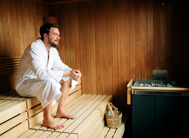 Handsome man relaxing in sauna and staying healthy