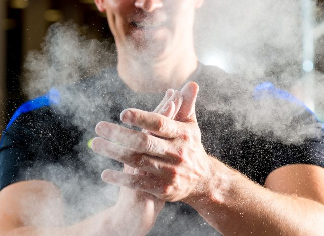 male hands smeared talcum powder close up