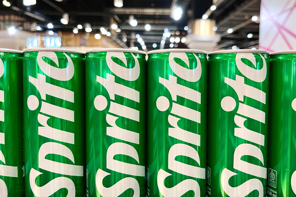 Jakarta, Indonesia - May 24th, 2024 - Sprite green can packaging design isolated on supermarket row shelf display background.