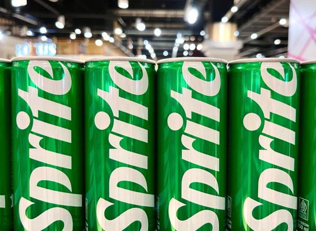 Jakarta, Indonesia - May 24th, 2024 - Sprite green can packaging design isolated on supermarket row shelf display background.