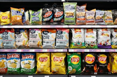 SELANGOR, MALAYSIA - 27 FEB 2022. Various imported brands of flavoured chips and snacks on store shelf in Village Grocer store. Village Grocer is the coolest fresh premium supermarket in Malaysia.
