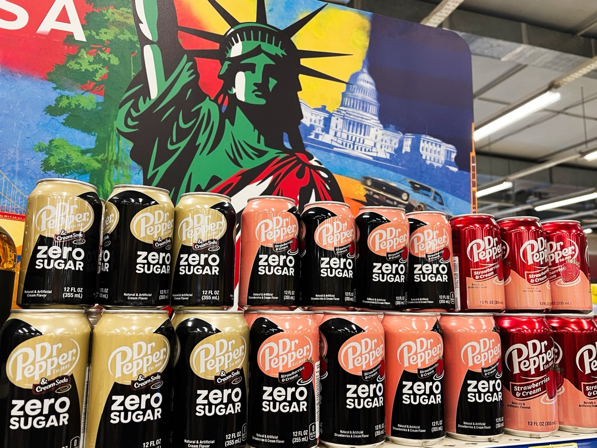 Kyiv, Ukraine - February 04, 2025: A colorful display of Dr Pepper Zero Sugar cans with a patriotic background.