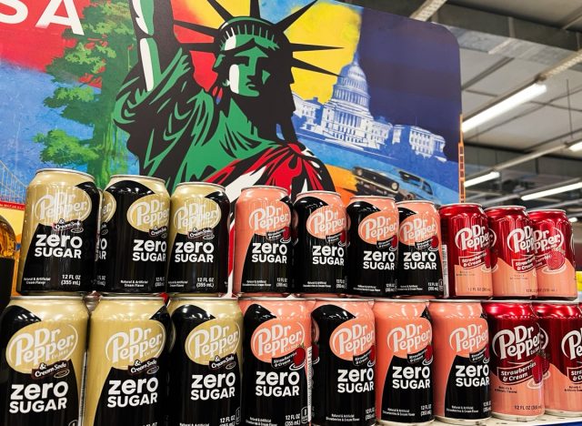 Kyiv, Ukraine - February 04, 2025: A colorful display of Dr Pepper Zero Sugar cans with a patriotic background.