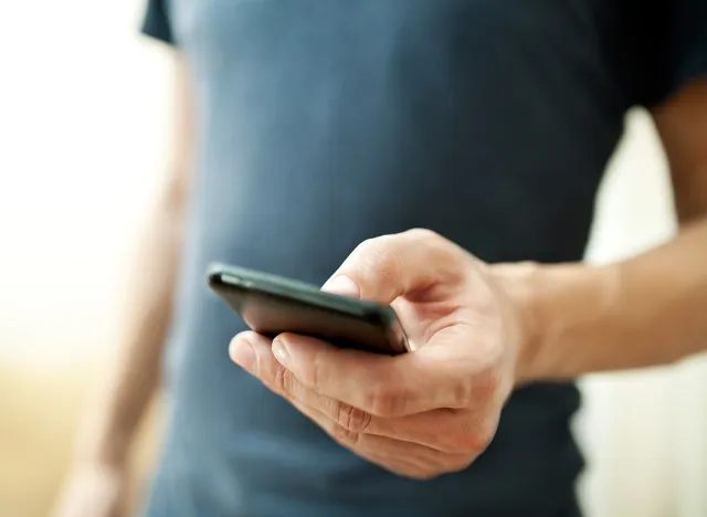 Close up of a man using mobile smart phone