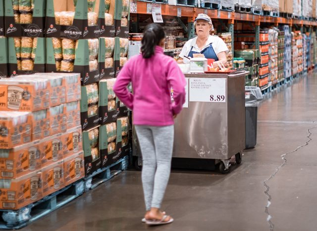 Costco wholesale warehouse shopping aisle with food testing