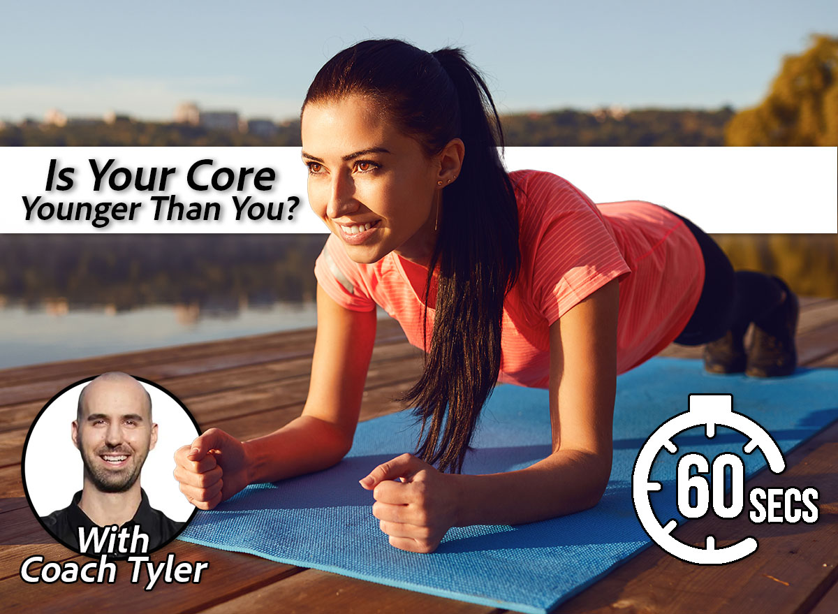 Girl does a plank exercise by the lake on nature