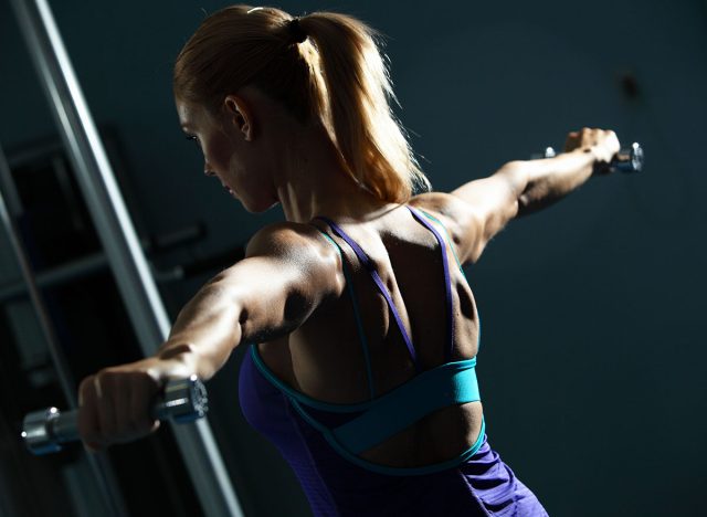 Image of fitness girl in gym exercising with dumbbells