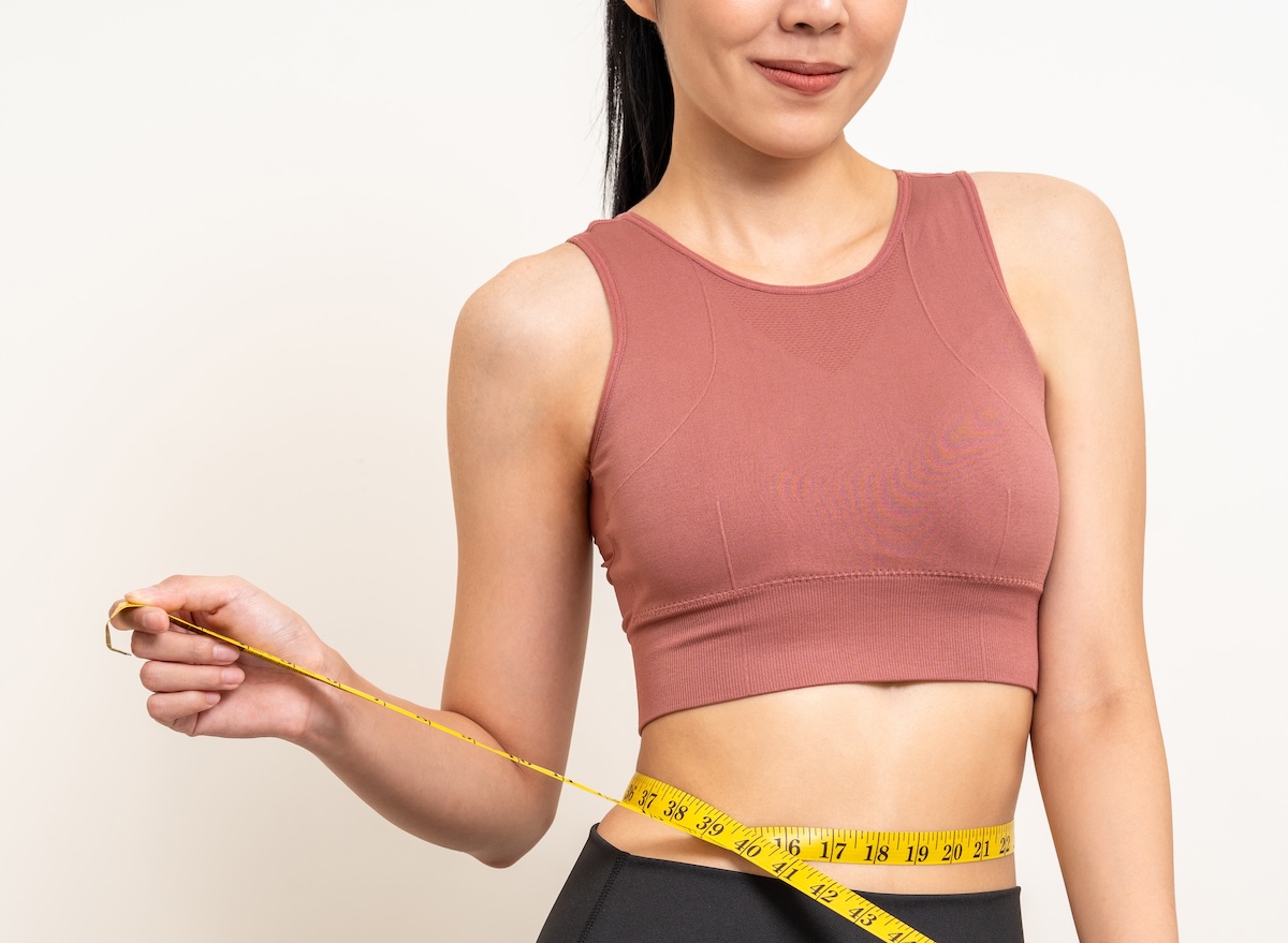 Close,Up,Woman,Measuring,Her,Waistline,With,Measure,Tape.,Weight