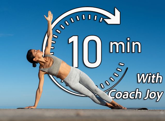 Side plank yoga pose with extended arm under the clear blue sky,