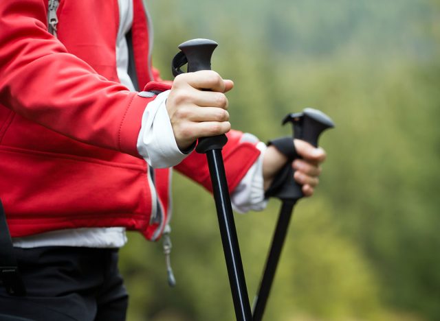 Nordic Walking in Autumn mountains, hiking woman