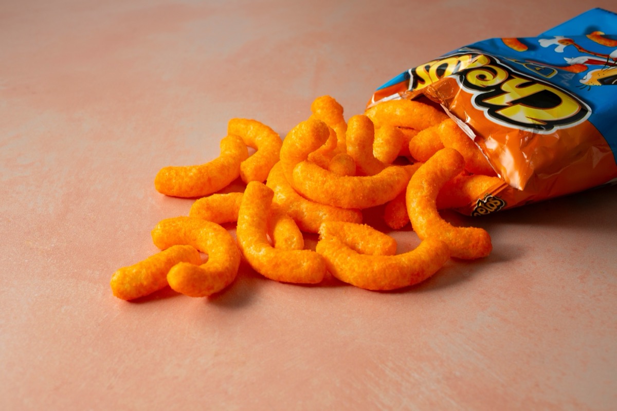 Los Angeles, California, United States - 08-14-2024: A view of a pile of Cheetos puffs spilling out of the bag.