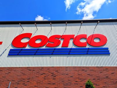 Raleigh, North Carolina - May 2 2025: Costco Wholesale Gold Star Membership Card Held In Hand in Front of Storefront Location