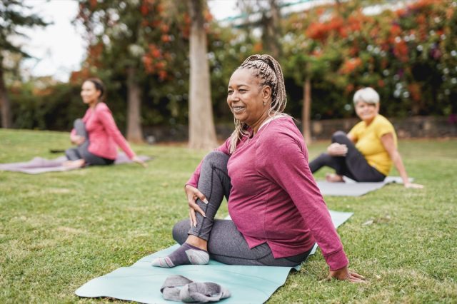 Multiracial women doing yoga exercise