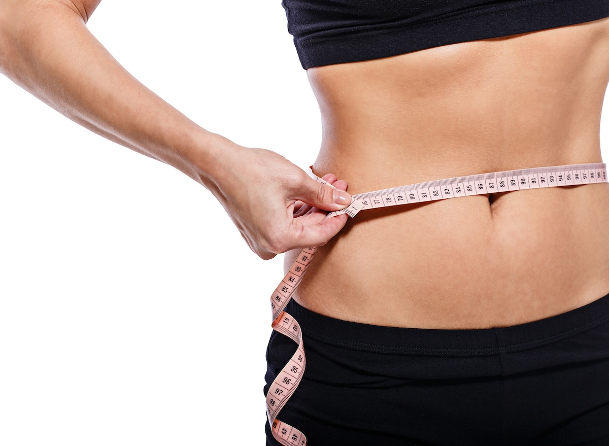 Girl,Measuring,Waist,Circumference,After,A,Grueling,Workout,,Isolated,On