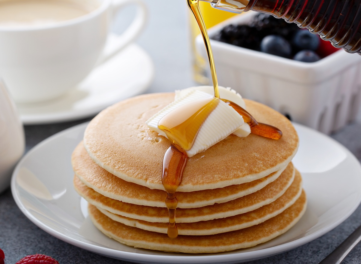 Stack,Of,Pancakes,With,Butter,And,Syrup,Pouring,Over,,Clean