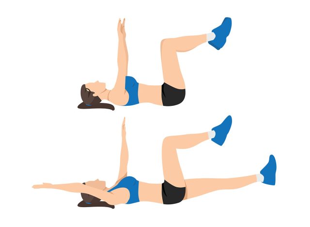 A person performing a dead bug exercise with weights.