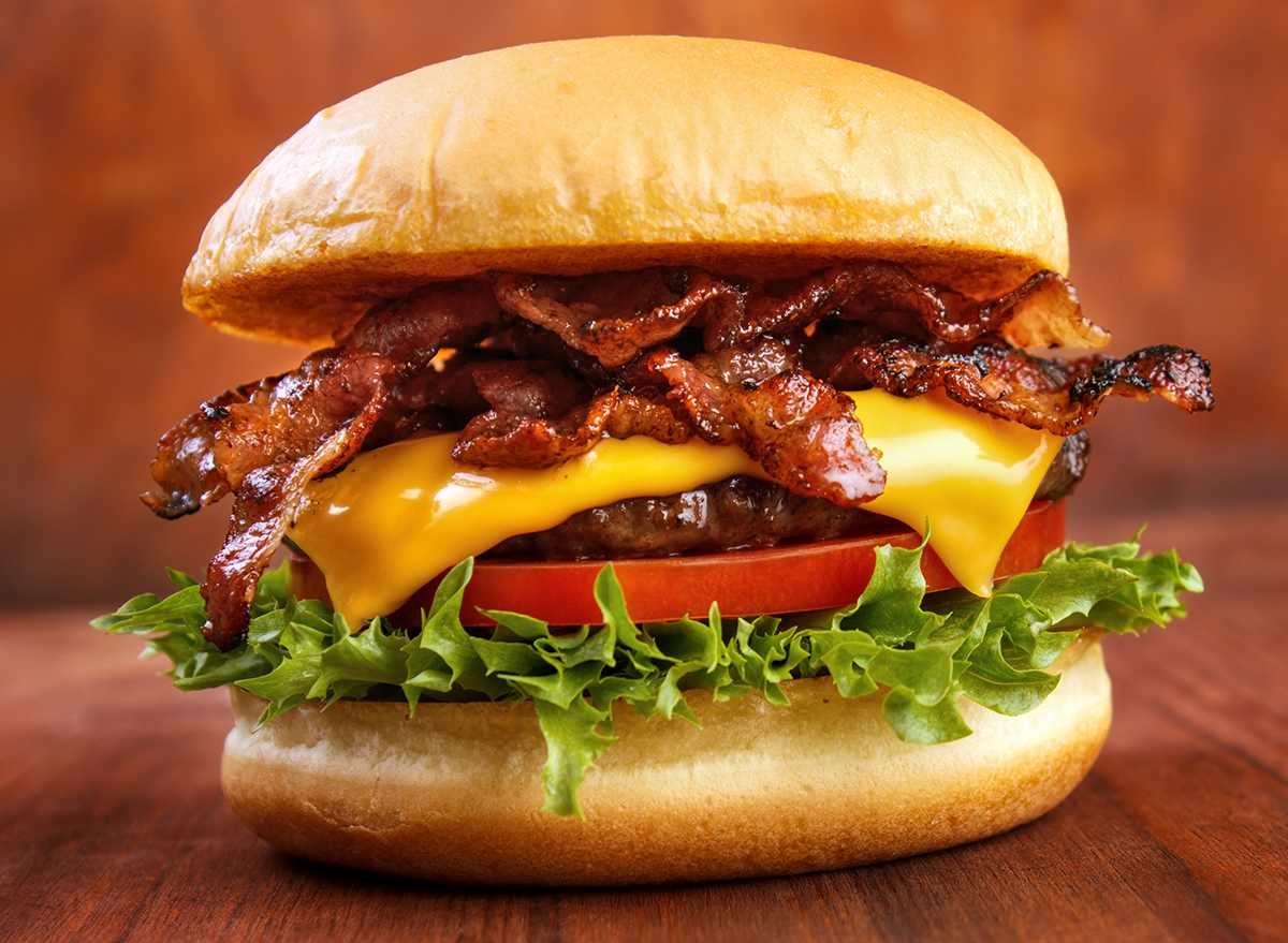Bacon burger with beef patty on wooden table