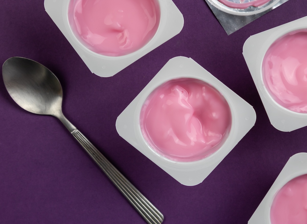 Fruit,Flavoured,Yogurt,In,White,Plastic,Cups,On,Bright,Purple