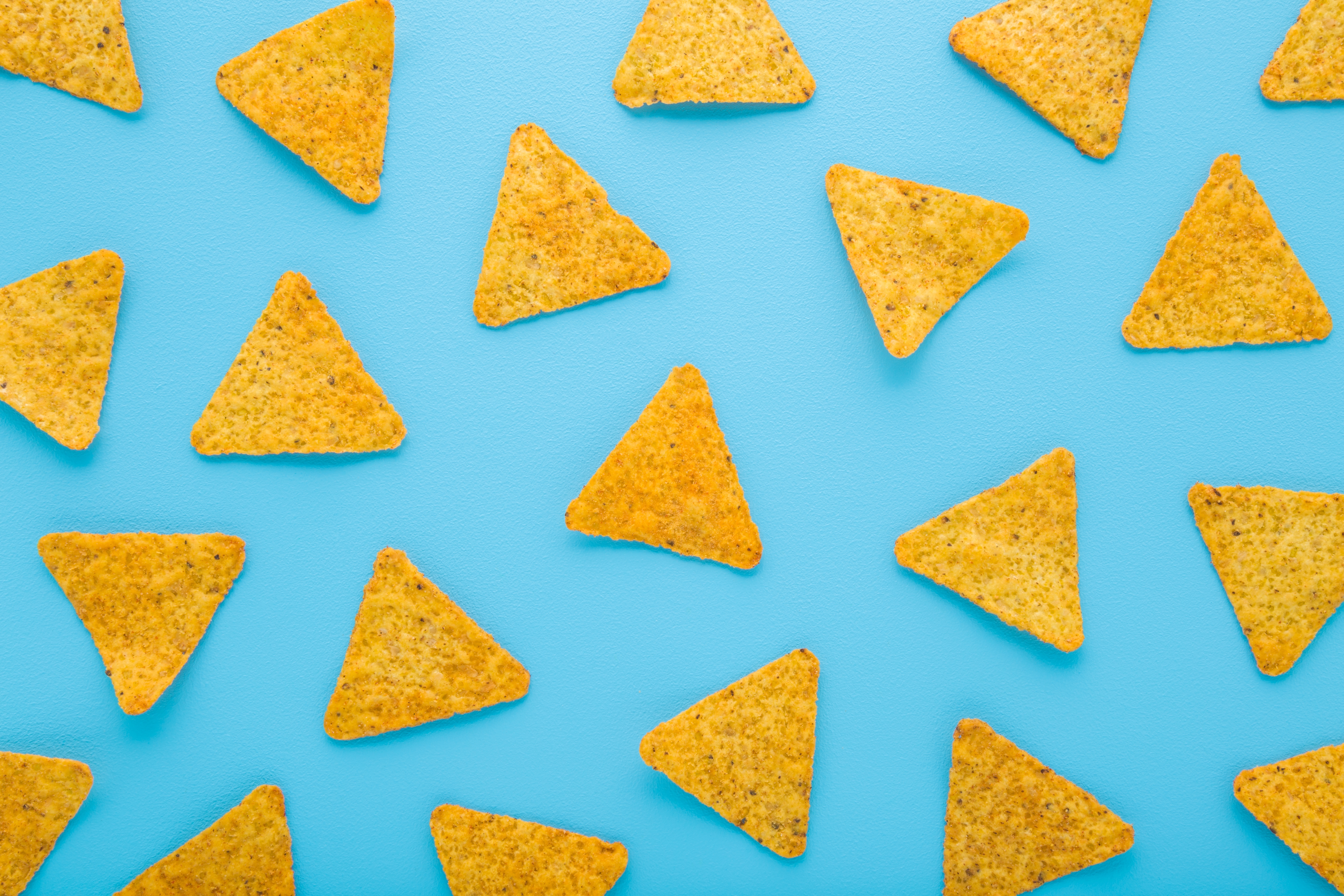 Yellow,Tortilla,Chips,On,Light,Blue,Table,Background.,Pastel,Color.