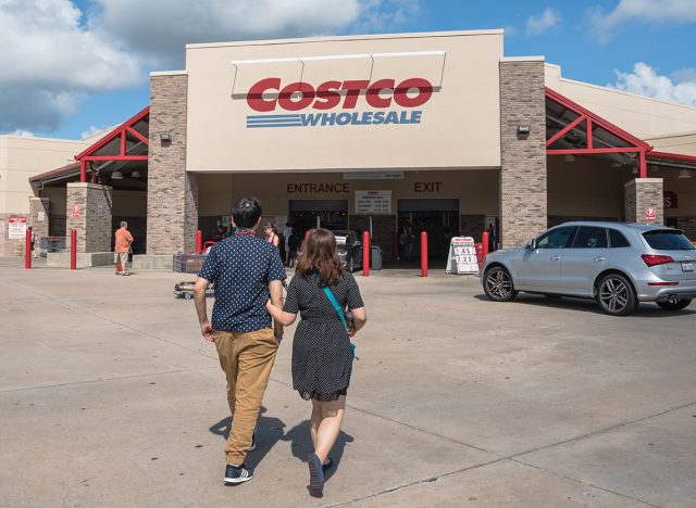Costco Wholesale storefront with customers walk in. Costco Wholesale Corporation is largest membership-only warehouse club in US. It has a total of 705 warehouses worldwide