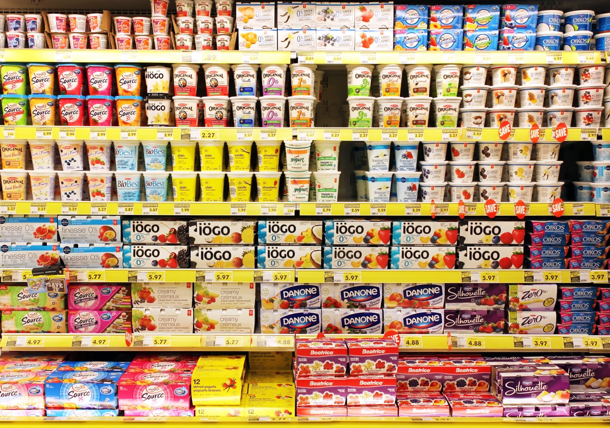 TORONTO, CANADA - OCTOBER 31, 2014: Different brands of yogurt on shelves in a supermarket. Yogurt is nutritionally rich in protein, calcium, riboflavin, vitamin B6 and vitamin B12.