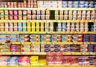 TORONTO, CANADA - OCTOBER 31, 2014: Different brands of yogurt on shelves in a supermarket. Yogurt is nutritionally rich in protein, calcium, riboflavin, vitamin B6 and vitamin B12.