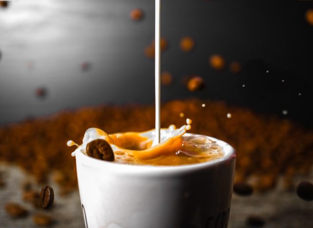 Coffee Beans falling while creamer mixes with coffee