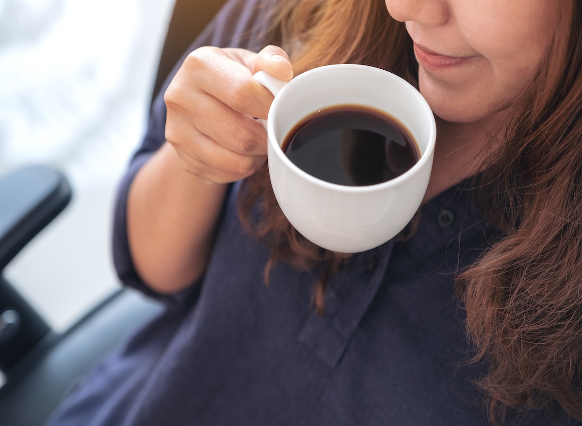 A,Beautiful,Asian,Woman,Holding,And,Drinking,Hot,Coffee,With