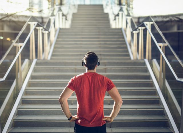 Man in red shirt preparing for stair run.