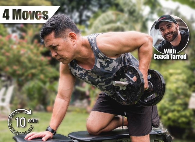 A fit and healthy asian man exercises outdoors at his home, doing one arm dumbbell rows on a bench.The 4 Strength Moves Every Man Over 50 Needs for Longevity. Cover
