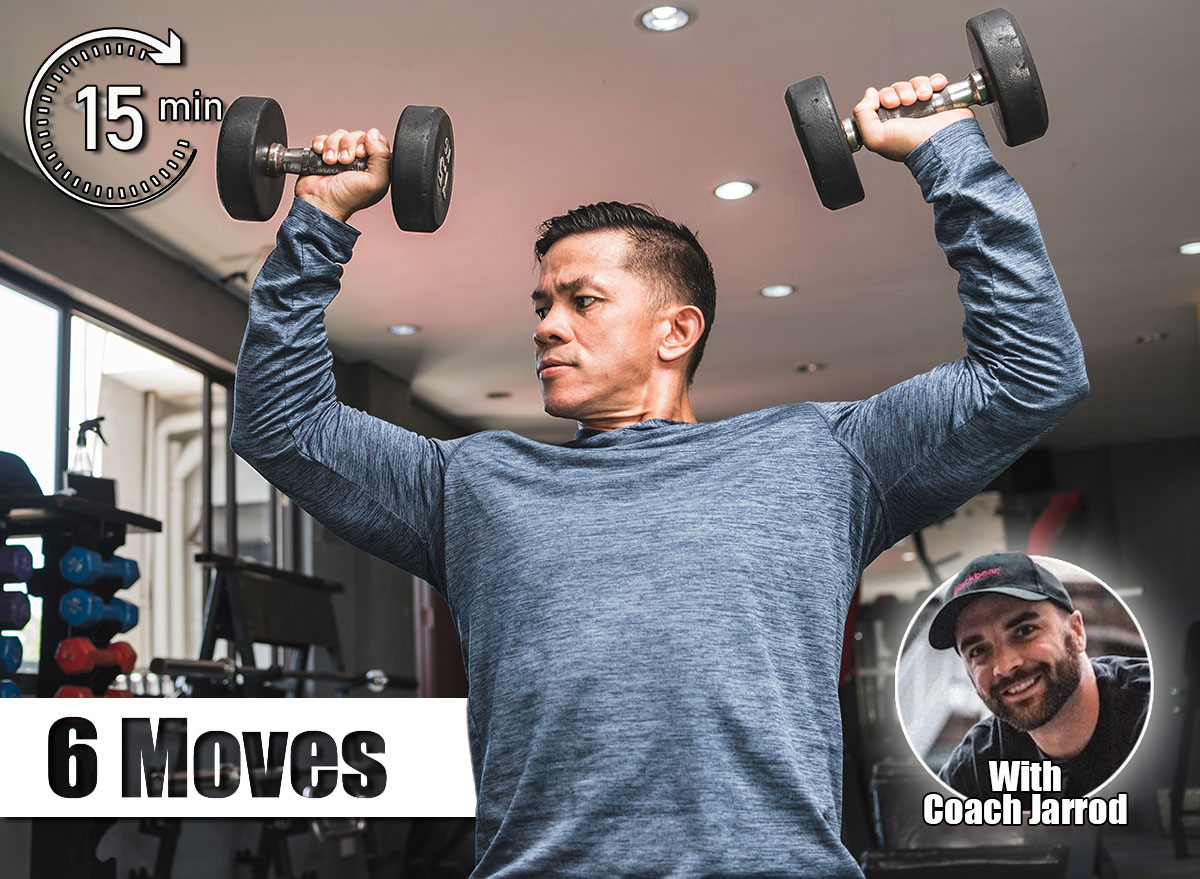 A health conscious man in his early 40s doing seated dumbbell presses. Maintaining a healthy physique in middle age. 6 Standing Moves That Build Strength Without Getting on the Floor After 50. Cover