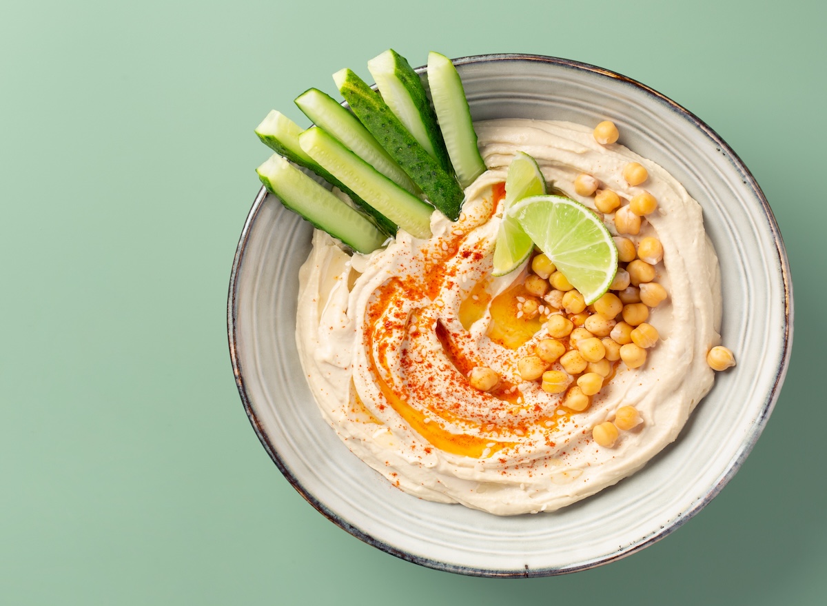 Hummus,In,Ceramic,Bowl,Over,Light,Green,Background.,Top,View,
