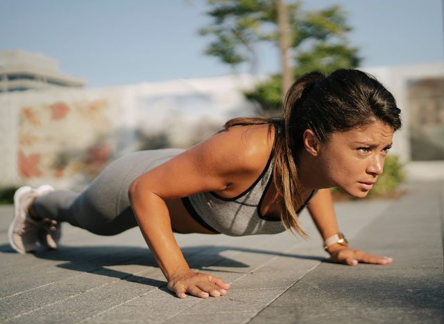 Fit athlete woman in sportswear outdoors. Young woman training in the park