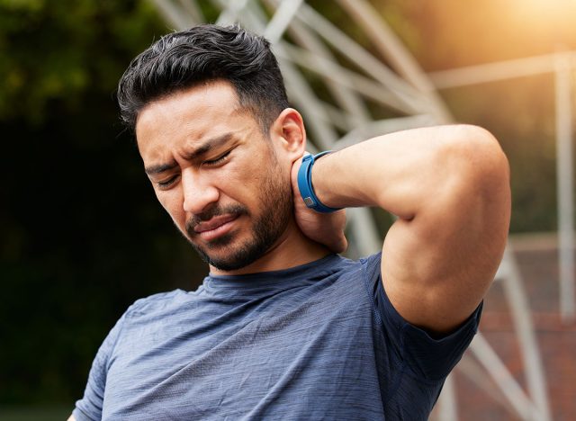 Sports, man and neck pain for basketball injury from workout, fitness and exercise in competition games. Face, asian athlete and player on court with health risk, accident and first aid for wound