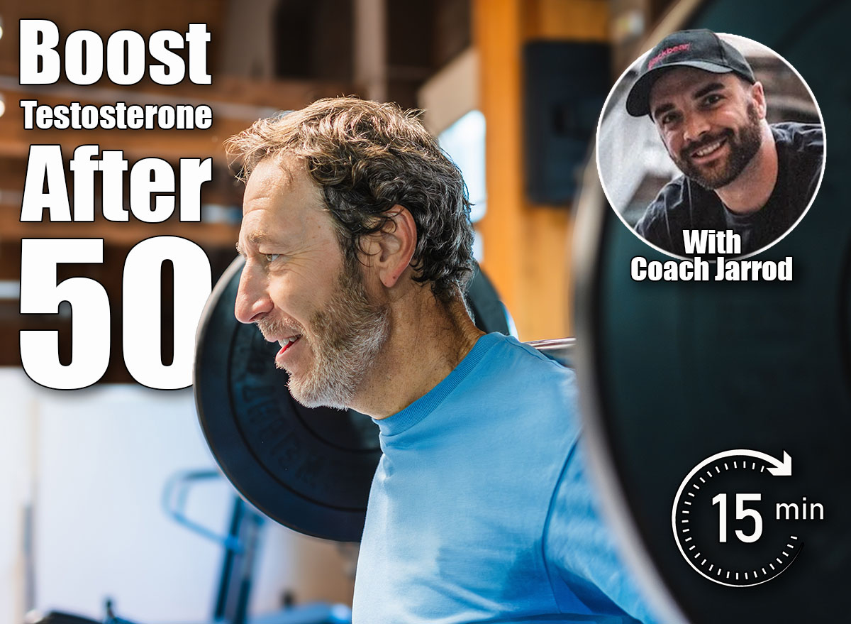 Portrait of a mature man lifts a barbell with weighted discs in a gym. He is training his leg strength by performing squats. He smiles and enjoys himself. 3 Strength Moves Every Man Over 50 Should Do to Boost Testosterone Naturally. Cover