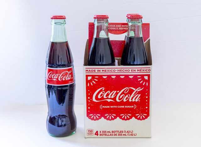 A four pack of Mexican Coca Cola bottles.