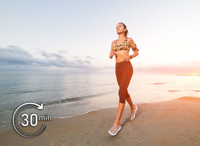 Cute fit tanned girl in sport top and leggings running on beach at sunset. Fitness, workout and healthy lifestyle concept. Blue sky in the morning with clouds. This Simple Japanese Walking Trick Could Help You Live Longer. Cover