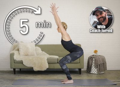A blonde woman in a black leotard and leggings, standing on a yoga mat in a room, doing yoga, squatting down with her arms raised. This 5-Minute Morning Routine Builds More Strength Than Hour-Long Workouts After 50. Cover