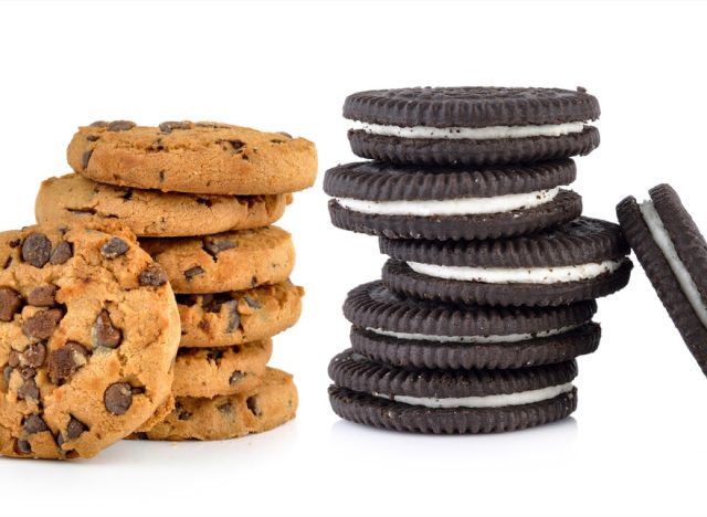 Chocolate chip and sandwich cookies with cream on white background