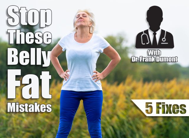 Adult woman with hands on hips looking upwards while wearing blue pants and white tee shirt with blurry yellow flowers in background. 5 Belly Fat Mistakes Everyone Makes According to This Doctor. Cover